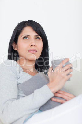 Woman holding a book and a mug