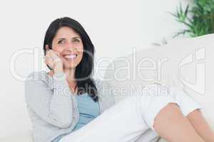Woman smiling while telephoning