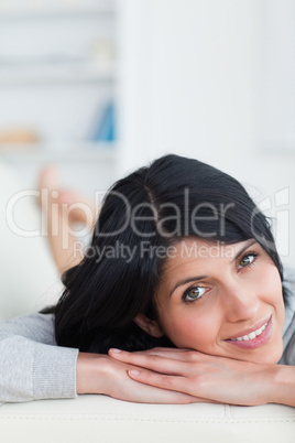 Smiling woman with her hand on her arms Smiling woman with her hand on her arms