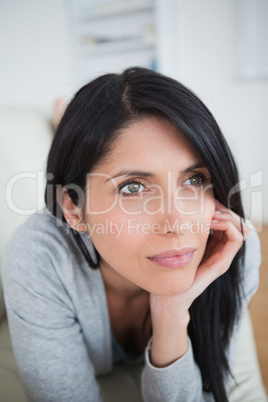 Woman holding her head with her palm