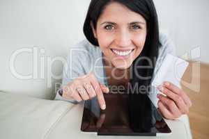 Woman with a tactile tablet and a credit card