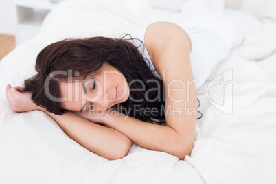 Woman falling asleep on her bed
