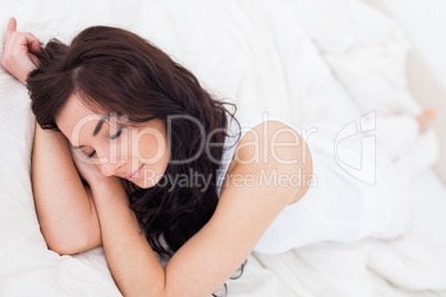 Peaceful woman sleeping on her bed