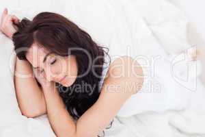 Peaceful woman sleeping on her bed