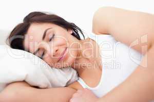 Peaceful woman lying while sleeping in the morning