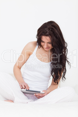 Smiling brunette woman using her touchscreen