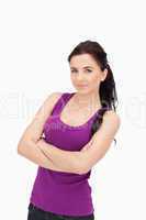 Brunette in purple top tank with folded arms