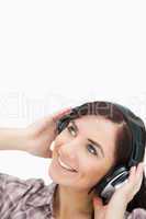 Woman enjoying music with headphones while looking up