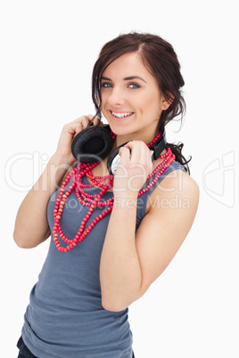 Smiling student holding her headphones