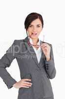Seductive business woman putting her glasses in her mouth