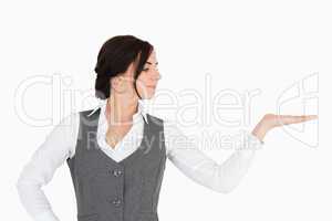 Young businesswoman looking at her palm facing up