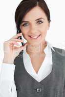 Blue eyed brunette in suit on the phone