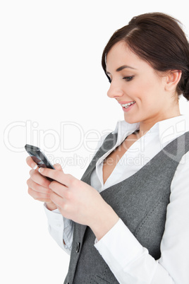 Attractive businesswoman text-messaging