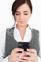 Brunette in suit reading a text-message