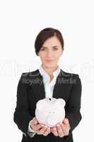 Businesswoman holding a piggy-bank