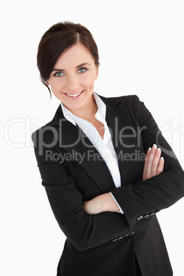Smiling blue eyed woman in suit with arms folded