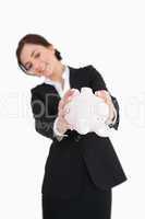 Businesswoman emptying a piggy-bank