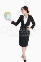 Attractive businesswoman holding an earth globe