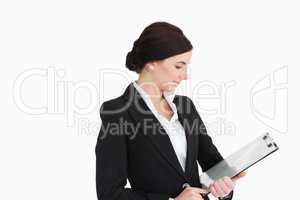 Woman in suit looking at a clipboard