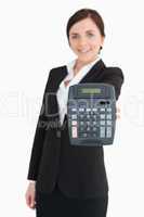 Businesswoman in black suit showing a calculator