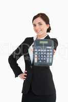 Smiling businesswoman in black suit showing a calculator