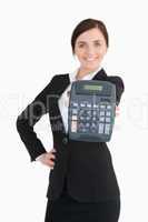 Happy businesswoman in black suit showing a calculator