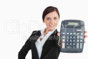 Woman in black suit showing a calculator