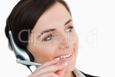 Woman in suit using a headset