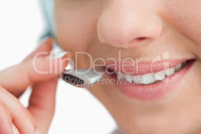 Close-up on a smiling businesswoman mouth speaking in headset