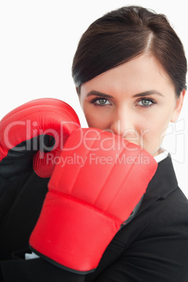 Businesswoman wearing red boxing gloves