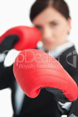 Businesswoman boxing with red gloves