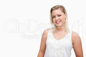 Smiling blonde woman standing upright