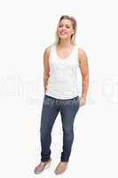 Woman standing upright with her hands in her pockets