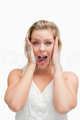 Surprised blonde woman standing with her mouth opened