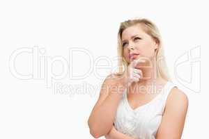 Blonde woman placing her fingers on her chin
