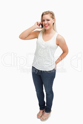 Cheerful blonde woman holding her cellphone