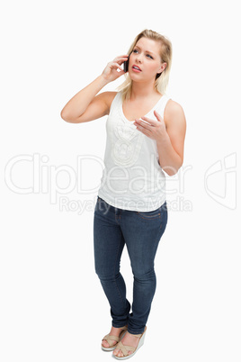 Serious blonde woman having a conversation on the phone