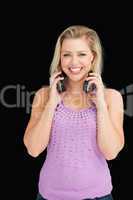 Smiling blonde woman holding her headphones