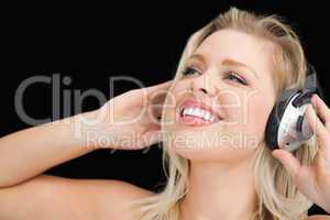 Cheerful blonde woman wearing headphones