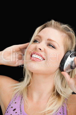 Joyful blonde woman listening to music