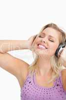 Blonde woman leaning her head while listening to music