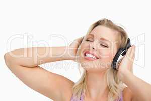 Woman listening to music while closing her eyes