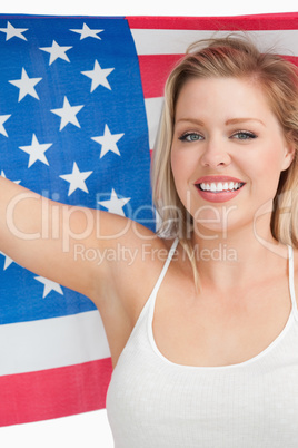 Smiling woman holding the Old Glory flag