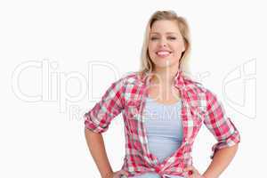 Smiling blonde woman putting her hands on her hips