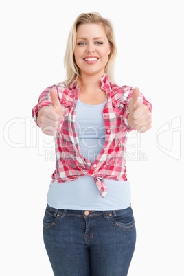 Happy blonde woman showing her two thumbs up