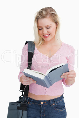 Smiling blonde woman reading a novel