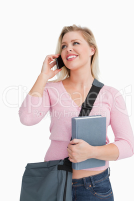 Smiling woman looking away while talking on the phone