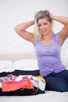 Blonde tearing her hair with her full suitcase