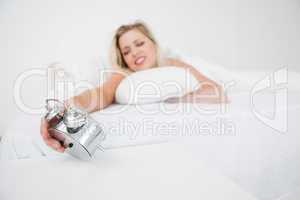 Woman looking at her alarm clock