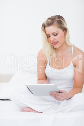 Young woman using an ebook while sitting